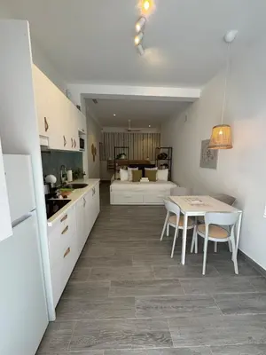 a kitchen and dining room with a table and chairs at Loft in Valencia, equipped and very well decorated in Valencia