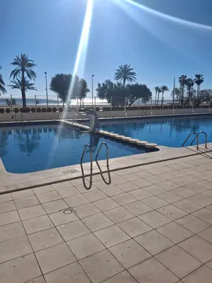 a pair of scissors in front of a swimming pool at Arensol Playa de Cullera in Cullera