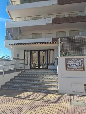 a building with a gate and stairs in front of it at Arensol Playa de Cullera in Cullera