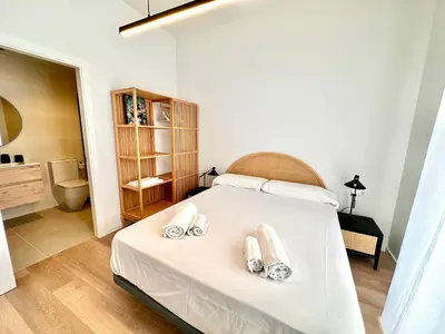 a bedroom with a bed with towels on it at Filologo Sanelo Luxury Apartaments in Valencia