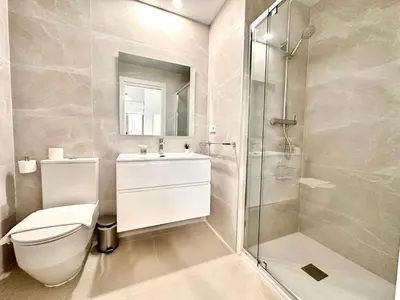 a bathroom with a toilet and a glass shower at Filologo Sanelo Luxury Apartaments in Valencia