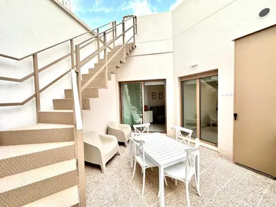 a patio with stairs and a table and chairs at Filologo Sanelo Luxury Apartaments in Valencia