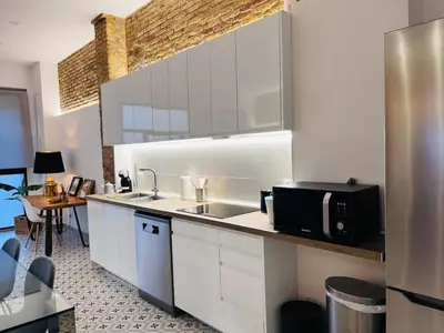 a kitchen with a sink and a microwave at Family Sea & Home Cabanyal in Valencia
