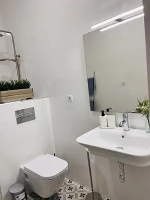 a white bathroom with a sink and a toilet at Family Sea & Home Cabanyal in Valencia