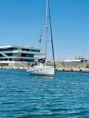 a white sail boat in the water near a dock at Family Sea & Home Cabanyal in Valencia