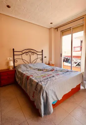 a bedroom with a bed and a large window at 2 Bed Apartment, Great Location, 500M from Beach in Valencia
