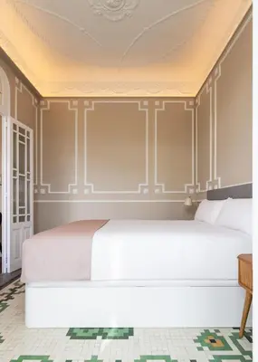 a bedroom with a white bed and a yellow ceiling at Limehome Valencia de Xativa in Valencia