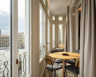 a room with a table and chairs and a window at Limehome Valencia de Xativa in Valencia