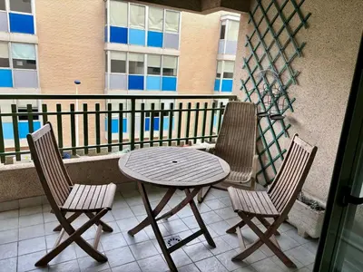 a wooden table and two chairs on a balcony at District Key - Valencia, Playa Patacona in Valencia