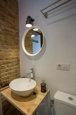 a bathroom with a white sink and a mirror at Cozy loft style apartment in El Cabanyal in Valencia
