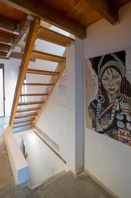 a painting of a woman on a wall with a staircase at Cozy loft style apartment in El Cabanyal in Valencia