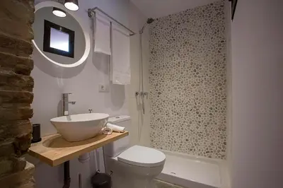 a bathroom with a sink and a toilet and a shower at Cozy loft style apartment in El Cabanyal in Valencia