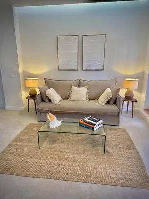 a living room with a couch and a glass table at Luxury apartment in Cabanyal in Valencia