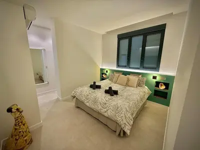 a bedroom with a large bed with a window at Luxury apartment in Cabanyal in Valencia