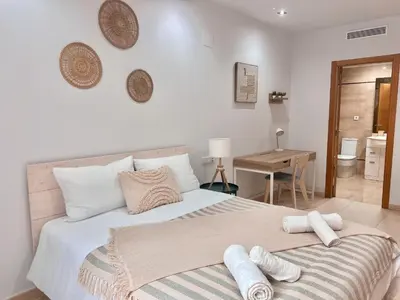 a bedroom with a large bed with towels on it at Apartamento Mare Nostrum in Valencia