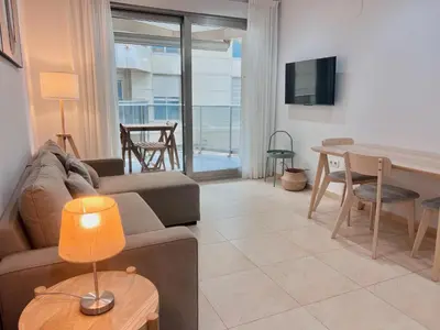 a living room with a couch and a table at Apartamento Mare Nostrum in Valencia