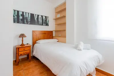 a bedroom with two beds and a night stand with a lamp at Dictrict Key - Pobla de Farnals, Carabelas in Puebla de Farnals
