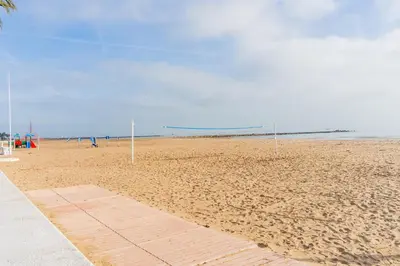 a sandy beach with two soccer goals on it at Dictrict Key - Pobla de Farnals, Carabelas in Puebla de Farnals