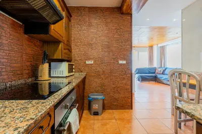 a kitchen with a counter top and a couch at Dictrict Key - Pobla de Farnals, Carabelas in Puebla de Farnals