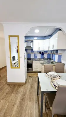 a kitchen and dining room with a table and chairs at La Casita de Camelia in Valencia