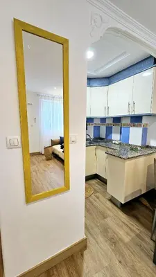 a mirror on a wall next to a kitchen at La Casita de Camelia in Valencia