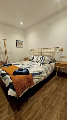 a bedroom with a bed with a blanket on it at La Casita de Camelia in Valencia