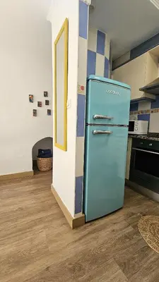 a blue refrigerator in a kitchen with a floor at La Casita de Camelia in Valencia