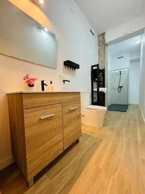 a bathroom with a large wooden dresser in a room at ORI A Cool & wide apartment next to historic center in Valencia