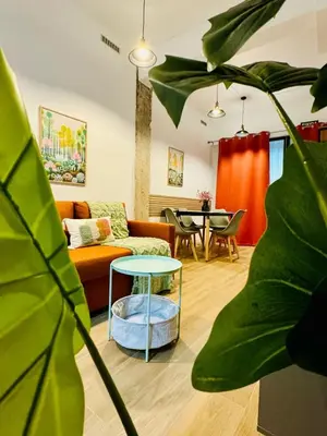 a living room with a couch and a table at ORI A Cool & wide apartment next to historic center in Valencia