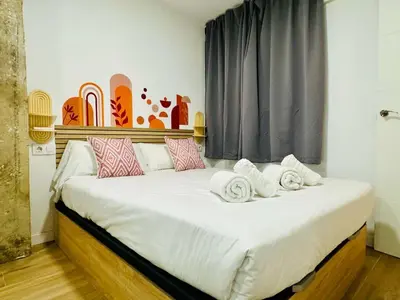 a bedroom with a large bed with towels on it at ORI A Cool & wide apartment next to historic center in Valencia