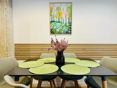 a dining room table with yellow plates and a vase with flowers at ORI A Cool & wide apartment next to historic center in Valencia