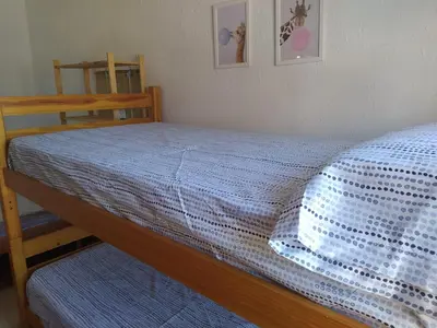a bedroom with a bed with a blue comforter at El Almazán in Buñol
