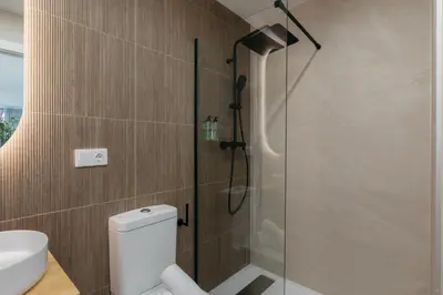 a bathroom with a toilet and a glass shower at Design loft in Valencia in Valencia