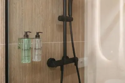 two glass bottles on a shelf in a bathroom at Design loft in Valencia in Valencia