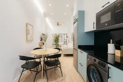 a kitchen and dining room with a table and chairs at Design loft in Valencia in Valencia