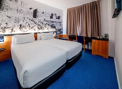 a hotel room with a bed and a desk at Hotel Sercotel Plana Onda in Onda