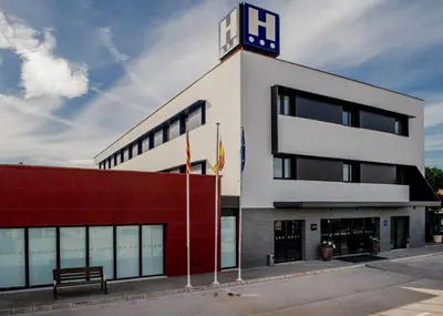 a building with a clock tower on top of it at Hotel Sercotel Plana Onda in Onda