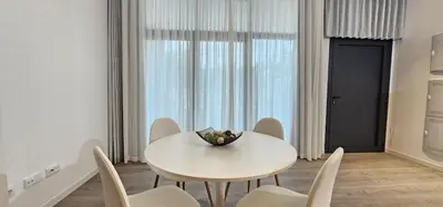 a white dining room with a white table and chairs at Vacansis Masamagrell Bajo Loft Tomas y Valiente in Masamagrell