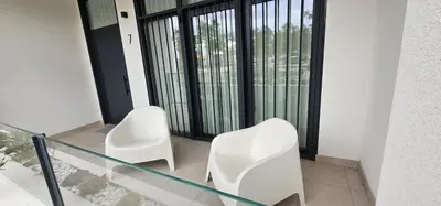 two white chairs sitting next to a glass table at Vacansis Masamagrell Bajo Loft Tomas y Valiente in Masamagrell
