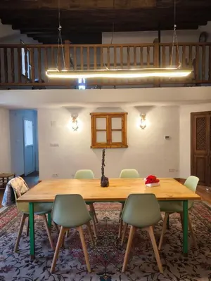 a dining room with a wooden table and chairs at Beautiful mountain chalet in Siete Aguas