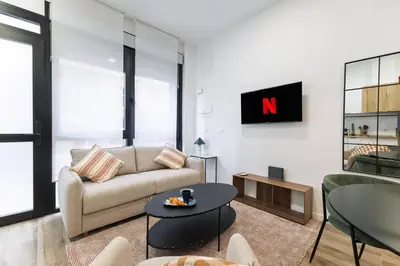 a living room with a couch and a table at Moderno loft reformado, Smart TV, AC, Beach, 3Pax in Valencia