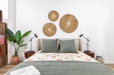 a bedroom with a bed and three hats on the wall at Moderno loft reformado, Smart TV, AC, Beach, 3Pax in Valencia
