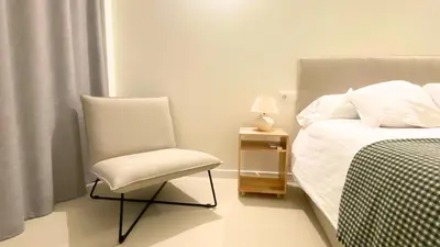a bedroom with a chair next to a bed at El Apartamento in Valencia