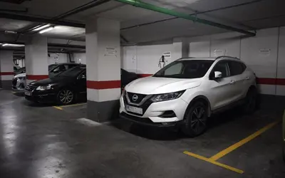 a white car parked in a parking garage at Apartment with views of the Mediterranean- Little Venice in Port Saplaya