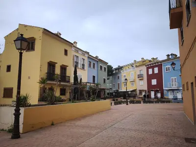 a street with many buildings and a street light at Apartment with views of the Mediterranean- Little Venice in Port Saplaya