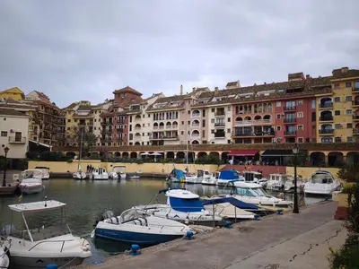 a group of boats docked in a harbor with buildings at Apartment with views of the Mediterranean- Little Venice in Port Saplaya