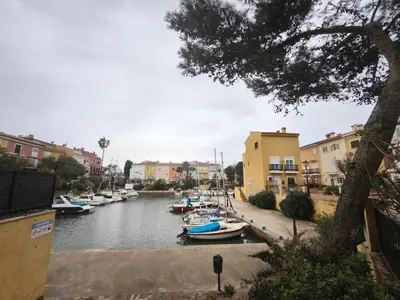 a group of boats docked in a river with buildings at Apartment with views of the Mediterranean- Little Venice in Port Saplaya