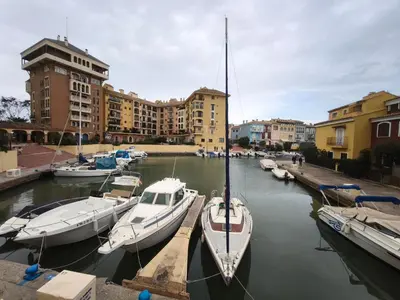 a group of boats docked in a harbor with buildings at Apartment with views of the Mediterranean- Little Venice in Port Saplaya