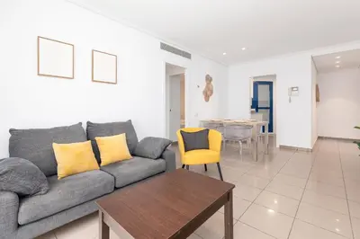 a living room with a couch and a table at ApartUP Patacona Iconic I in Valencia