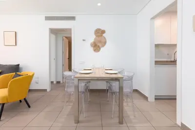 a dining room with a table and chairs at ApartUP Patacona Iconic I in Valencia